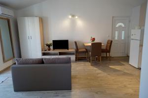 a living room with a couch and a table at Apartments Sanja in Jezera