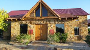 a building with a sign on the front of it at Almond Cabin in Fredericksburg