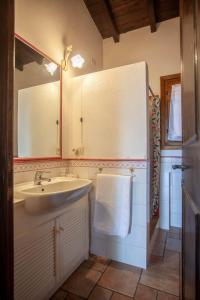 a bathroom with a sink and a mirror at Villa Kalè - Klodge in Olbia