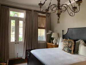 a bedroom with a bed and a chandelier at Terrell House Bed and Breakfast in New Orleans