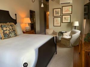 a bedroom with a large bed and two chairs at Terrell House Bed and Breakfast in New Orleans