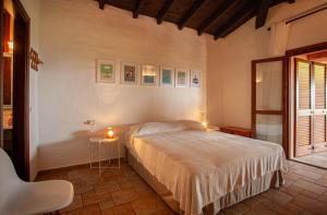 a bedroom with a bed and a table with a candle at Villa Kalè - Klodge in Olbia