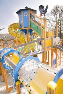 a playground with a slide and a roller coaster at Ganzebeek 14 pers. bungalow in Voorthuizen