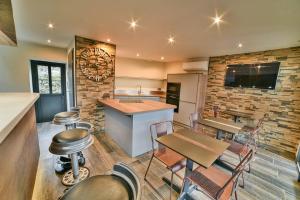 a kitchen and dining room with a table and chairs at LES TANNERIES in Ornans