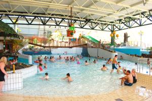 a group of people in a pool at a water park at HH van Craenwick Appartement in De Hutte