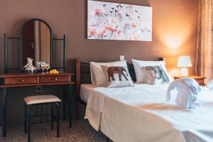 a bedroom with a bed and a dresser and a mirror at Roxanne’s Home in Limenas