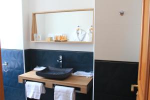 a bathroom with a sink and a mirror at Le Diana Hôtel & Spa NUXE in Carnac