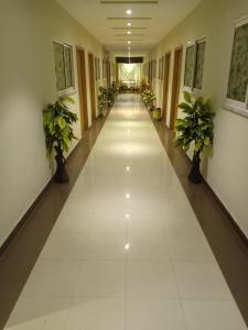 an empty hallway in a building with potted plants at BnB Hotel in Lahore