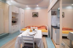 a small room with a table and two beds at White Pearl Apartment in Belgrade