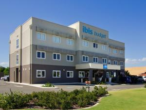 a large building with aubs provider sign on it at ibis Budget Perth Airport in Perth