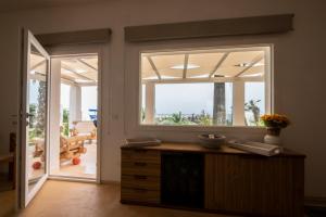a kitchen with a window and a view of the ocean at Villa Acquamarina sul mare in San Vito lo Capo