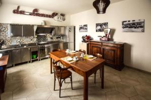 a kitchen with a wooden table and a dining room at gambisa street in Soliera