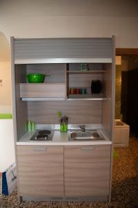 a kitchen with a sink and a counter top at Green Apartment in Rosolina Mare