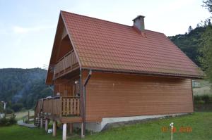 a large wooden building with a red roof at Domki pod Honem w Cisnej in Cisna