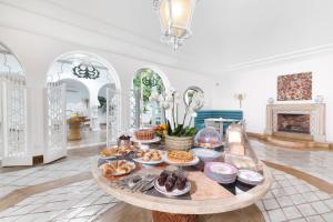 a table with food on it in a room with a fireplace at Relais Villa Savarese in Sant'Agnello