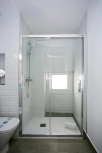 a shower with a glass door in a bathroom at MONKÓ - COCO & TROPYCAL APARTMENT o in Torremolinos +19 photos