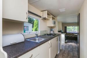 a kitchen with a sink and a counter top at RA Reeënveld Mobile home in Arnhem