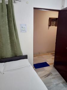 a bedroom with a bed and a sliding door at Hotel Alka in Varanasi