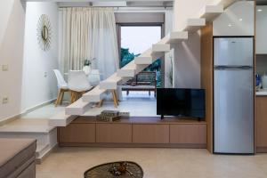 a living room with a staircase with a tv at Alba Al Mare Villette in Laganas