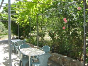 een rij tafels en stoelen in een tuin bij Studios Venetia in Astris