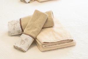 a pile of towels sitting on top of a bed at Villa Acquamarina sul mare in San Vito lo Capo +34 photos