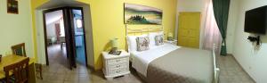 a bedroom with a bed and a television in it at Country House La Foggetta in Pineto