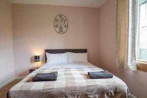a bedroom with a bed with two pillows on it at Montgomery Apartments - Stevensons in Edinburgh