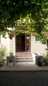 a house with stairs in front of a door at Vila Andre in 2 Mai