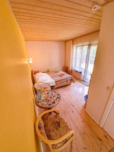 a room with two beds and two chairs in it at Mazā Kāpa in Koknese