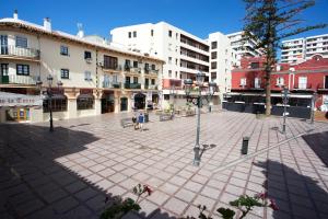 a city square with buildings and a street light at MONKÓ - KIWI & TROPYCAL APARTMENT o in Torremolinos