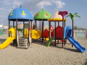 a playground on the beach with colorful playground equipment at Villa Angela in Lido delle Nazioni