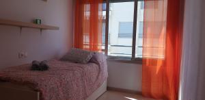 a bedroom with a bed with a pair of shoes on it at Punta Prima Pleamar in Orihuela Costa +9 photos