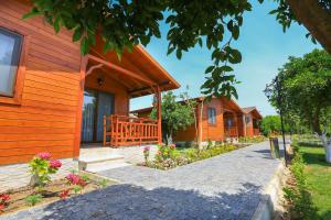 a row of cottages with flowers in front of them at Merry Bungalow & Tent in Cıralı