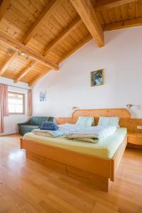 a bedroom with a large wooden bed in a room at Haus Wailand by Alpin Bookings in Dienten am Hochkönig