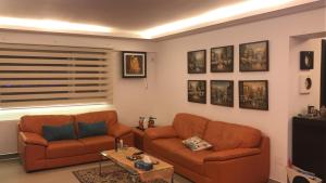 a living room with two couches and a tv at Ozana apartament in Constanţa