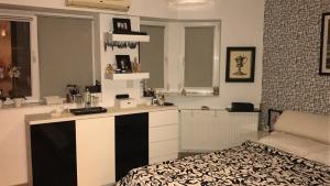 a room with a kitchen with a bed in it at Ozana apartament in Constanţa +58 photos