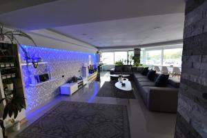 a living room with a couch and blue lighting at Ozana apartament in Constanţa