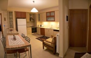 a kitchen with a table and a dining room at Villa Eleni in Drosia