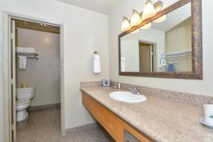 a bathroom with a sink and a toilet and a mirror at Super 8 by Wyndham Vallejo/Napa Valley in Vallejo