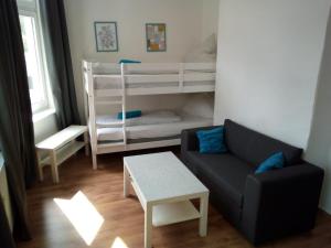 a living room with a couch and two bunk beds at Rickmersstraße 61 Bremerhaven in Bremerhaven