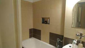 a bathroom with a bath tub and a sink at Apartament Relax in Sovata +42 photos