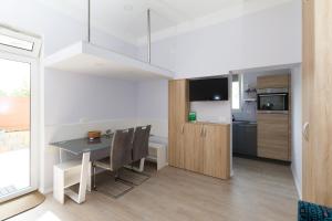 Pobegi的住宿－Apartmaji Sobe Zvezda，厨房以及带桌椅的用餐室。