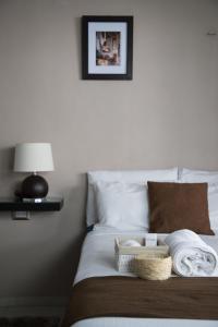 a bedroom with a bed with towels on it at Margarett Hotel in Valladolid