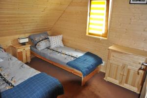 Posteľ alebo postele v izbe v ubytovaní Sosenka Domki