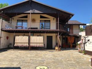 a large house with a balcony and a patio at Апартаменты SunRise in Kamianets-Podilskyi