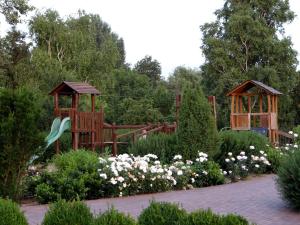 a garden with two gazebos and flowers at Villa La Vita in Hévíz