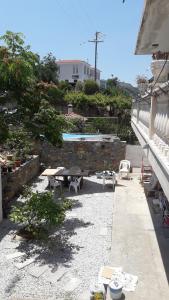un patio con mesa de picnic y piscina en Apartment with Sea View..., en Samos