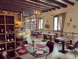 a restaurant with tables and chairs in a room at Auberge Saint-Jean in Villequier-Aumont +28 photos