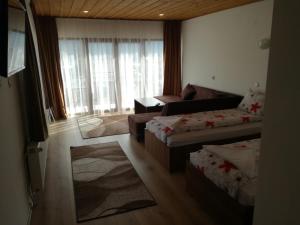 a living room with two beds and a couch at Къща Генчеви in Sarnitsa