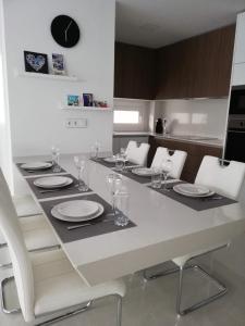 a table with plates and glasses on it in a kitchen at AMAY 880 Nr 38 in Torrevieja